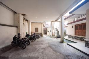 a row of motorcycles parked in an empty building at RedDoorz Plus near RS PMI Bogor in Bogor