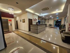 a lobby with a reception desk in a building at Veer Hotel in Kuantan