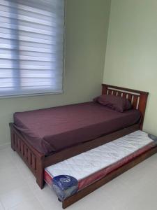 een slaapkamer met 2 bedden in een kamer met een raam bij 13 Avenue Homestay in Kota Bharu