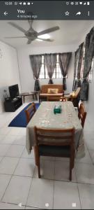 a living room with a table and a couch at Raudhah family homestay at KLIA 3rooms & 2bath room in Sepang