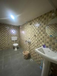 La salle de bains est pourvue d'un lavabo et de toilettes. dans l'établissement Winter Sky - a 2bhk beautiful apartment, à Tinsukia