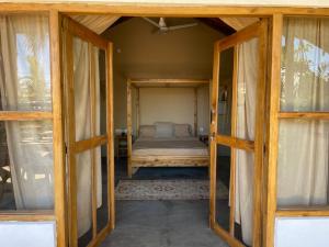 a room with a bed inside of a house at Gypsea Cabana in Arugam Bay +1 photo