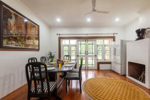 a dining room with a table and chairs at StayVista at Gaash Cottage - Pet Friendly Villa with Lawn, Bonfire, WiFi in Sonāmarg