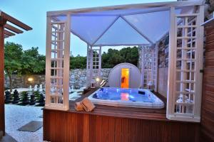 a jacuzzi tub in a house with a mirror at Ventoura Studios & Apartments in Galissas