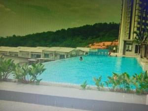 a large blue swimming pool with people in it at IPOH staycation in Ipoh