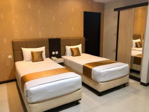 En eller flere senge i et værelse på Kana Citra Guesthouse
