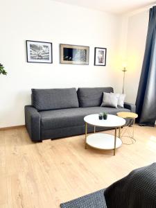 uma sala de estar com um sofá e uma mesa em Isabellas: Near to trainstation em Linz