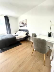 a bedroom with a bed and a table and a chair at Isabellas: Near to trainstation in Linz