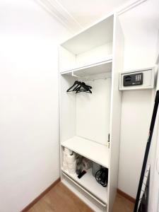 a walk in closet with white cabinets and a microwave at Isabellas: Near to trainstation in Linz