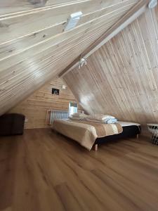 a bedroom with a bed in a attic at Stuga i Storklinten in Harads