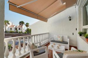 a balcony with white chairs and a white railing at Torviscas Endless Summer in Adeje