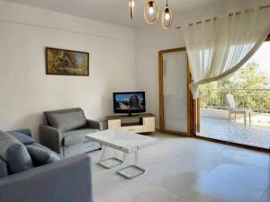 a living room with a couch and a table at Dhermi Village Apartments in Dhërmi