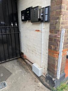 a pay phone on the side of a building at Cozy Retreat in Luton in Luton