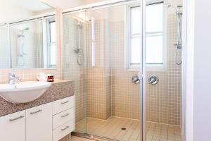 a bathroom with a shower and a sink at Grandview Apartments in Ballina