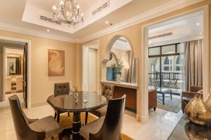 a dining room with a table and chairs at Classic & New - 1BR Apartment in OldTown,Downtown - Allsopp&Allsopp in Dubai