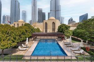 a swimming pool with a city skyline in the background at Classic & New - 1BR Apartment in OldTown,Downtown - Allsopp&Allsopp in Dubai