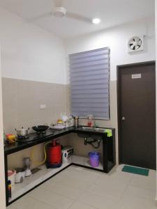 a kitchen with a counter with some food on it at HOMESTAY BATU PAHATKU- HOMESTAY IMAN in Batu Pahat
