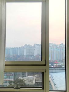 a window with a view of a city at Apartment near Ilsan Dongkuk University Hospital in Goyang