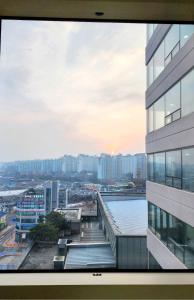 a view of a city from a window of a building at Apartment near Ilsan Dongkuk University Hospital in Goyang