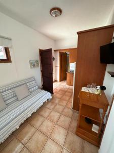 a bedroom with a bed and a table with a television at Casa Jesus in Fuencaliente de la Palma