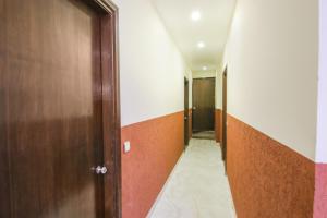 an empty hallway with a door and a hallway at FabExpress Kohinoor City in Chandīgarh