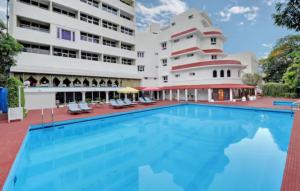 a swimming pool in front of a building at Ambassador Pallava in Chennai