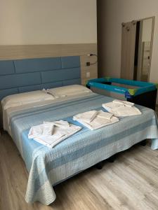 a bed with towels on it in a room at Il Sole e la Luna B&B in Garda in Garda
