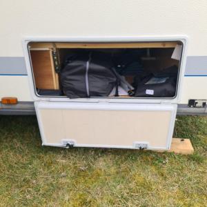 an open trunk of a trailer with luggage in it at Louise´s Camper in Neusiedl an der Zaya