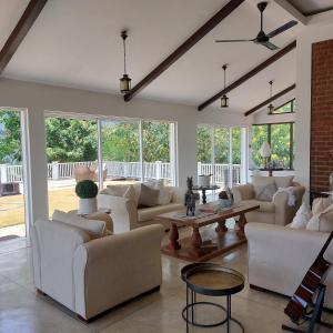 a living room with white couches and a table at VillaEliza in Matale