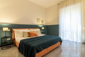 a bedroom with a large bed and a window at A Tutto Tondo Apartment - Lerici in Lerici