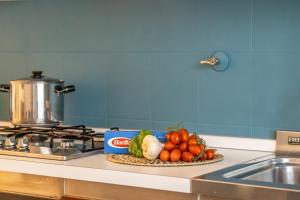 a plate of vegetables on a counter next to a sink at A Tutto Tondo Apartment - Comfort and Style in Lerici in Lerici