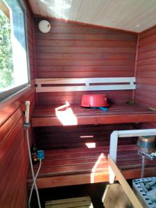 a room with a sauna with a red wall at Nelikko juhla- ja majoitustilat in Himanka +49 photos