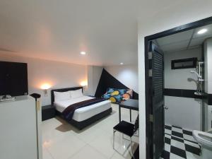 a bedroom with a bed and a bathroom at @Room Apartment in Ban Zong Katiam