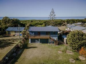 an aerial view of a house with the ocean in the background at Omaru Beach House in Scamander