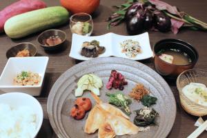 uma mesa com um prato de comida com arroz e legumes em KOKO HOTEL Premier Kanazawa Korinbo em Kanazawa