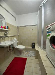 a bathroom with a toilet and a sink and a washing machine at single room, in Üsküdar in Istanbul