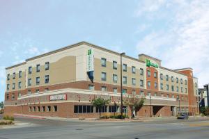 a large building on the corner of a street at Holiday Inn Omaha Downtown - Waterpark by IHG in Omaha