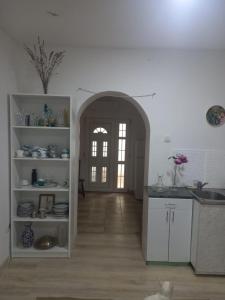 a kitchen with an archway leading to a door at Soul in Bela Crkva