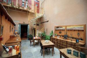 a large room with a spiral staircase in a building at La Maison des Consuls in Mirepoix