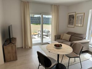 a living room with a couch and a table and chairs at Apartments Tenerifa in Novigrad Istria