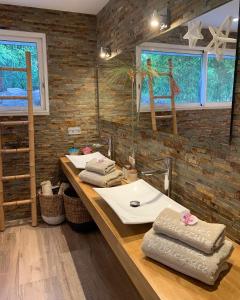 a bathroom with two sinks and two windows at B&B LES VOILES DE VALESCURE chambres d'hôtes et son espace bien être in Saint-Raphaël