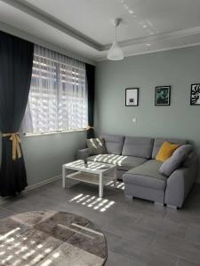 a living room with a couch and a table at Apartament Wałowa in Wejherowo