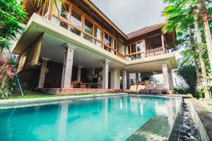 ein Haus mit Pool davor in der Unterkunft Warisan Villa by Supala in Ubud