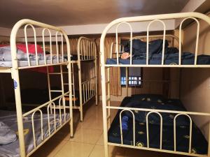 two sets of bunk beds in a room at TaSahin Hostel & Turkish Restaurant & Bar in Phnom Penh