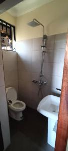 a bathroom with a toilet and a bath tub at cosy living in Gulu