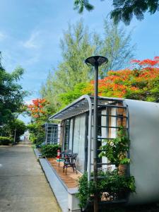 a house with a deck and a lamp post at An Hoa Residence in Long Hai