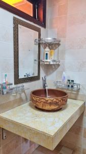 a bathroom with a wooden bowl sink on a counter at Rose House Sapa in Sa Pa