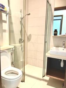 a bathroom with a shower and a toilet and a sink at 2 BR with city view near Subway in central in Singapore