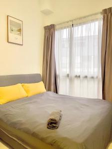 a bed in a bedroom with a large window at 2 BR with city view near Subway in central in Singapore