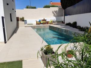 a swimming pool in the middle of a yard at Apto. El Pozo de las Nieves con piscina in Cobisa +9 photos